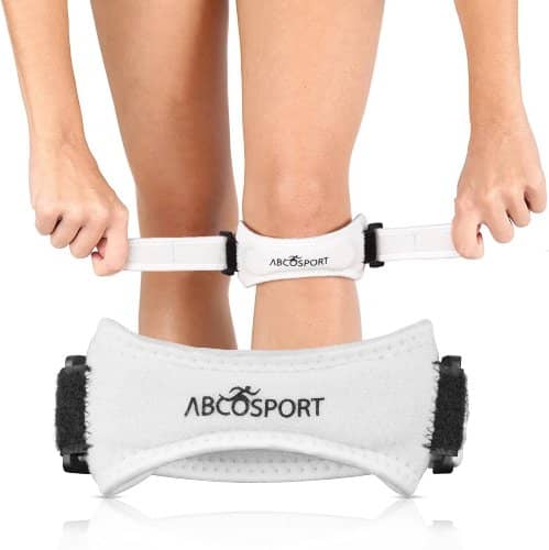 Woman putting on abco tech patella knee strap, best knee strap for football